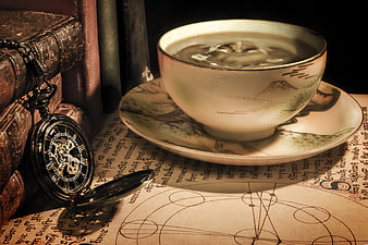 Vintage teacup and pocket watch on old manuscript