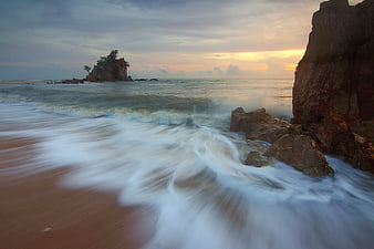 Long Exposure Sunset Ocean Waves Crashing on Rocky Beach