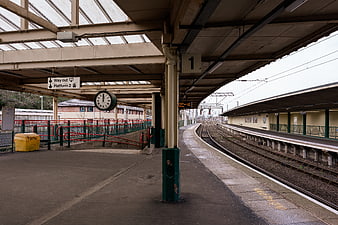 Empty Train Station Platform with Tracks and Clock