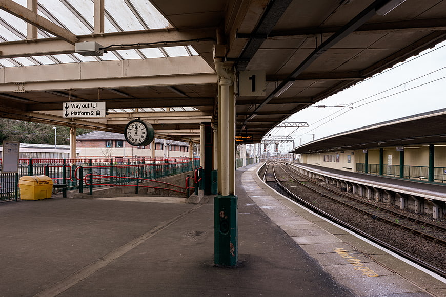 Empty Train Station Platform with Tracks and Clock
