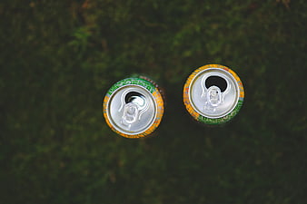 Top View of Two Soda Cans on Green Grass
