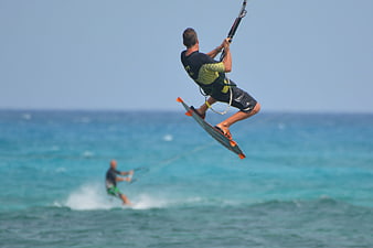 Kitesurfer Jumping High Over Blue Ocean Waves