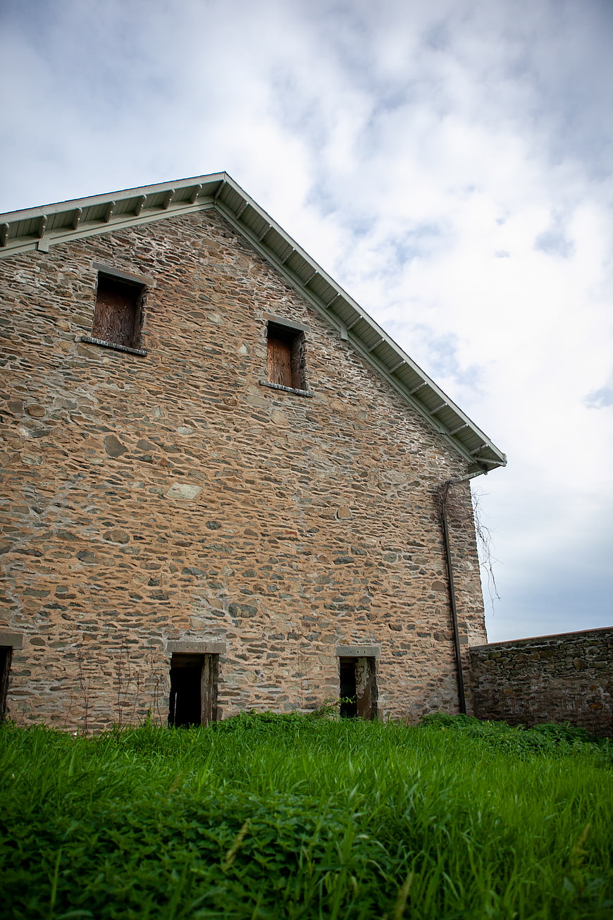 Old Stone Building Facade with Overgrown Grass