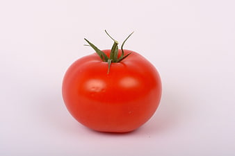 Single Fresh Red Tomato With Green Stem On White Background