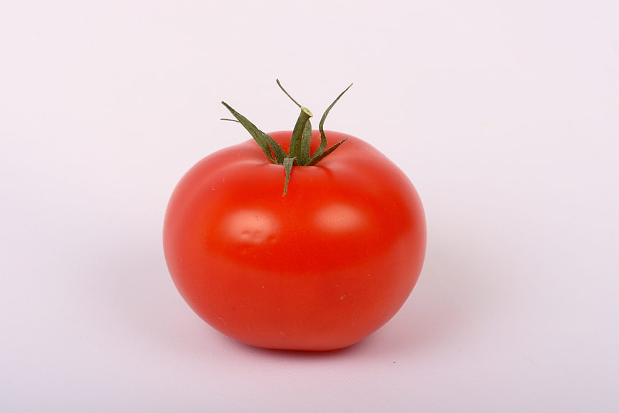 Single Fresh Red Tomato With Green Stem On White Background