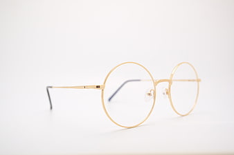 Gold round metal eyeglasses on white background