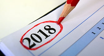 Red Pencil Circling 2018 on Calendar Page