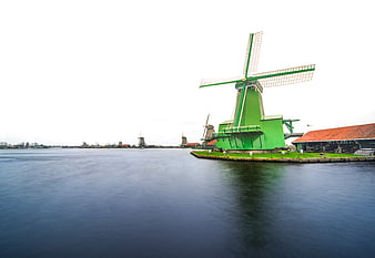 Traditional Green Dutch Windmill by the Water