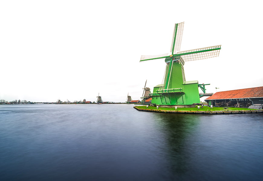 Traditional Green Dutch Windmill by the Water