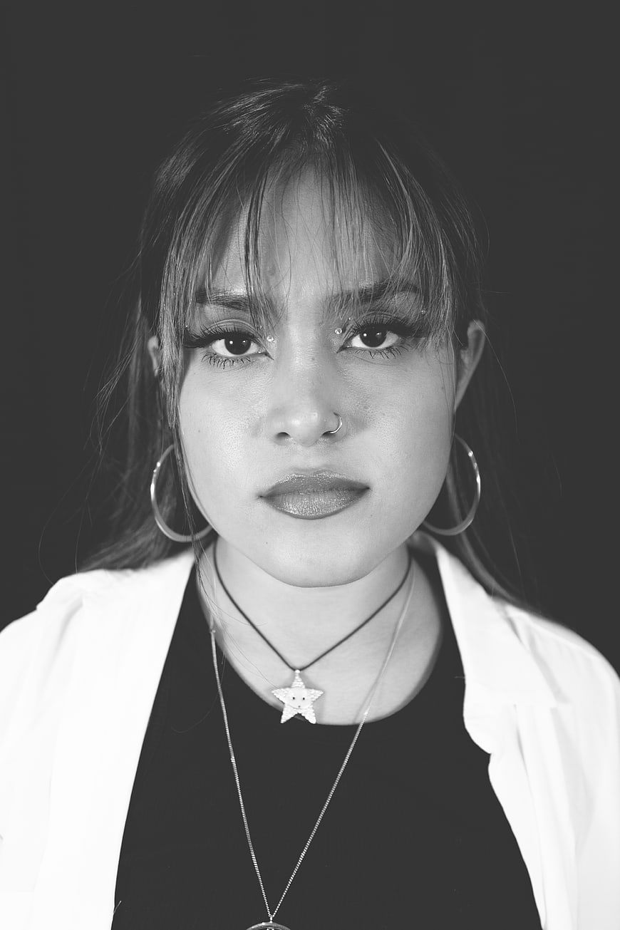 Black and white portrait of stylish young woman with hoop earrings