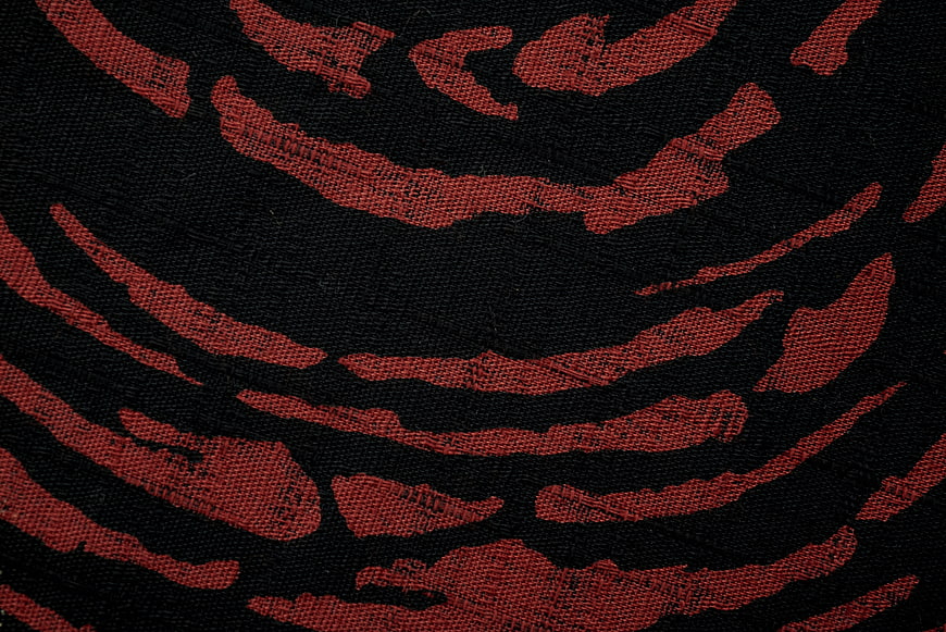Red and black woven fabric texture close up