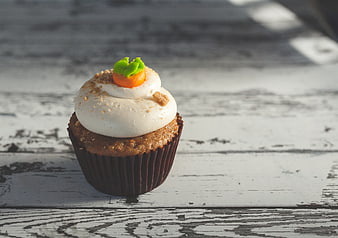 Carrot Cupcake with Cream Cheese Frosting on Rustic Wood
