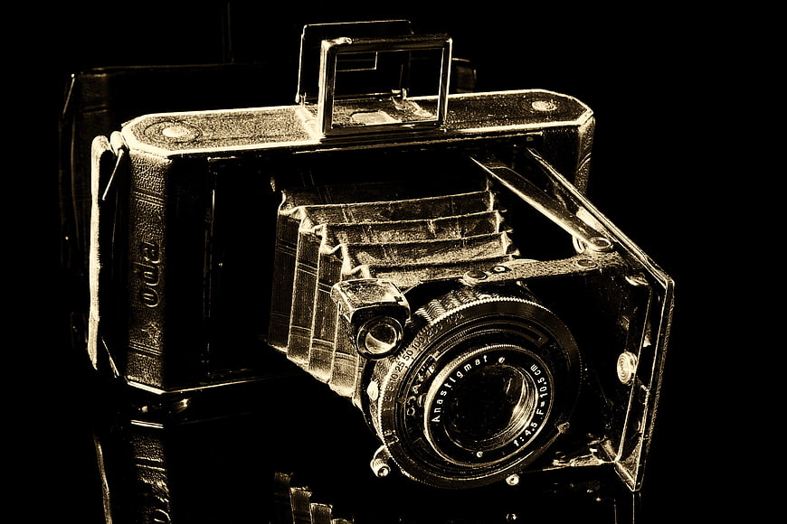 Vintage Sepia Tinted Folding Camera on Black Background