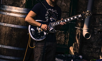 Male Guitarist Playing Electric Guitar on Street