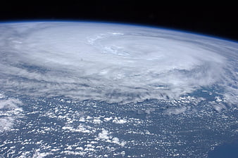 Aerial view of a massive hurricane swirling over the ocean from space