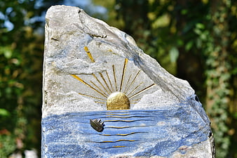 Carved Stone Memorial With Gold Sun And Ship