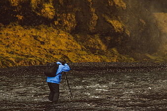 Photographer in Blue Jacket Shooting Landscape in River