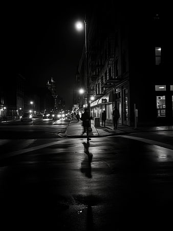 Moody Black and White Night Cityscape with Wet Street Reflections
