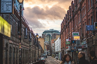 Urban Street Scene with Brick Buildings and Dramatic Sky