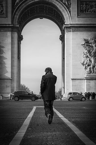 Man Running Away from Camera Under Arc de Triomphe