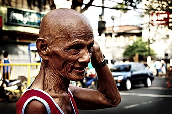 Portrait of elderly man on busy city street