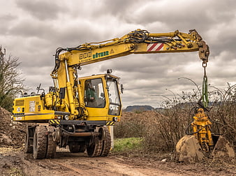 Yellow Liebherr excavator with hydraulic gripper on construction site