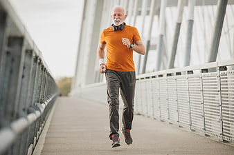Active Senior Man Running on Modern Bridge
