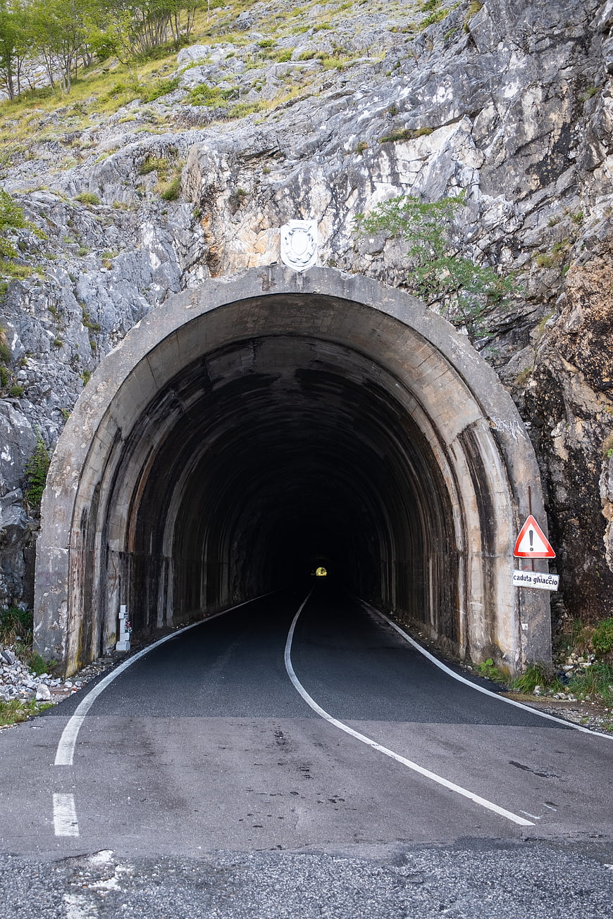 Mountain Road Tunnel Entrance with Warning Sign