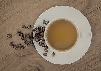 Top View of Coffee Cup with Beans on Wooden Table