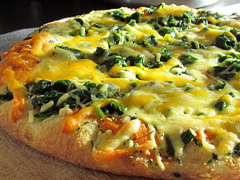 Homemade Spinach and Cheese Pizza on Wooden Board