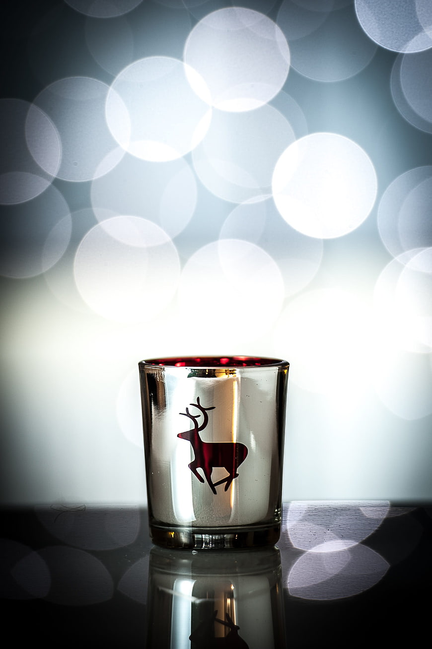 Christmas Tea Light Candle with Reindeer Silhouette and Bokeh Background