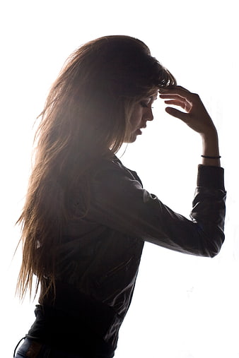 Backlit Portrait of Young Woman with Long Hair in Leather Jacket