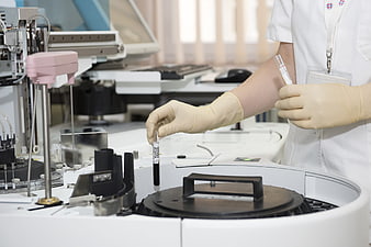 Laboratory Technician Handling Blood Sample in Medical Lab