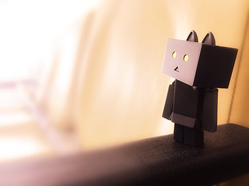 Black Danbo Cat Figure on Desk with Blurred Background