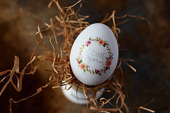 Hand-painted Easter egg with floral wreath and inspirational quote