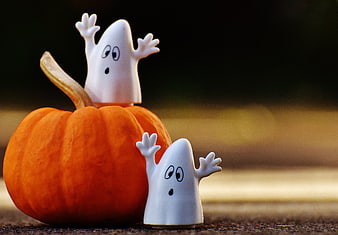 Cute Halloween Ghosts on Pumpkin with Bokeh Background