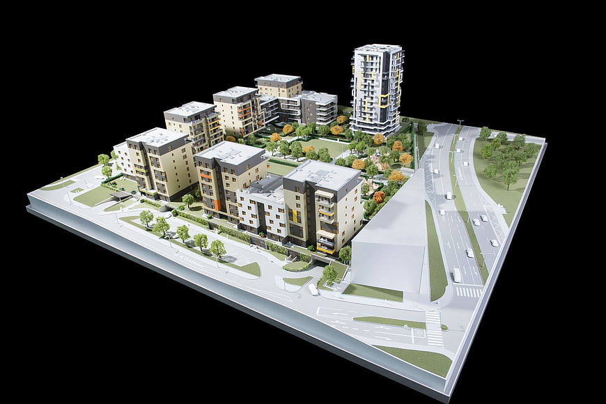 Architectural model of modern residential complex with high-rise tower