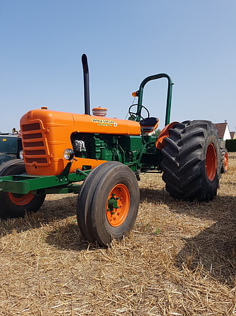 Vintage Orange and Green Tractor in Harvested Field