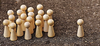 Wooden peg people representing one against all concept
