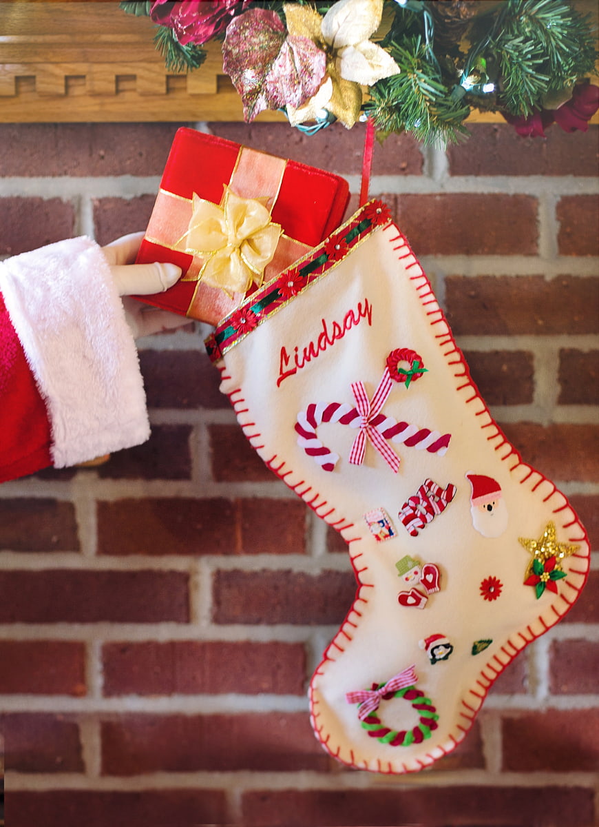 Santa's Arm Placing Gift in Personalized Christmas Stocking on Brick Fireplace
