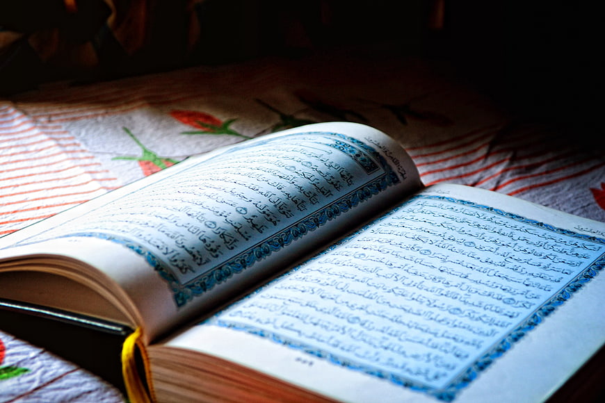 Open Holy Quran on Patterned Cloth with Soft Lighting