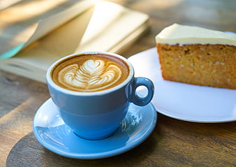 Blue Cup of Cappuccino with Latte Art and Cake
