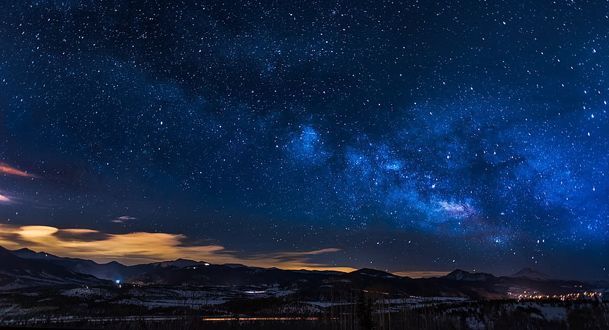 Milky Way Galaxy Over Snowy Mountain Landscape at Night