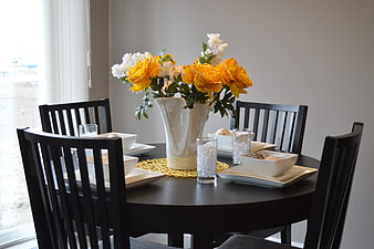 Elegant dining table setting with yellow and white peonies