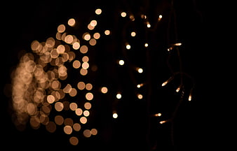 Warm bokeh lights on black background with depth of field
