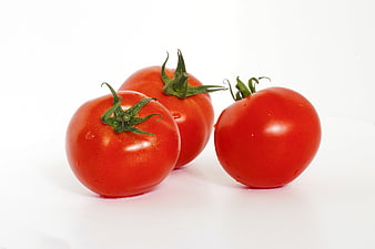 Three Fresh Red Tomatoes on White Background