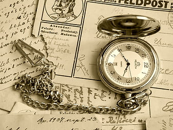 Vintage silver pocket watch on old handwritten letters