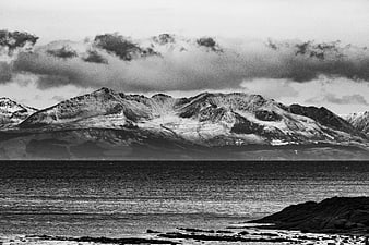 Dramatic Black and White Snowy Mountain Landscape by the Sea