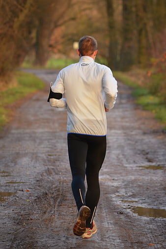 Man Running On A Dirt Path In A Forest