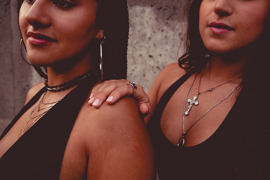 Close-up portrait of two women with hand on shoulder